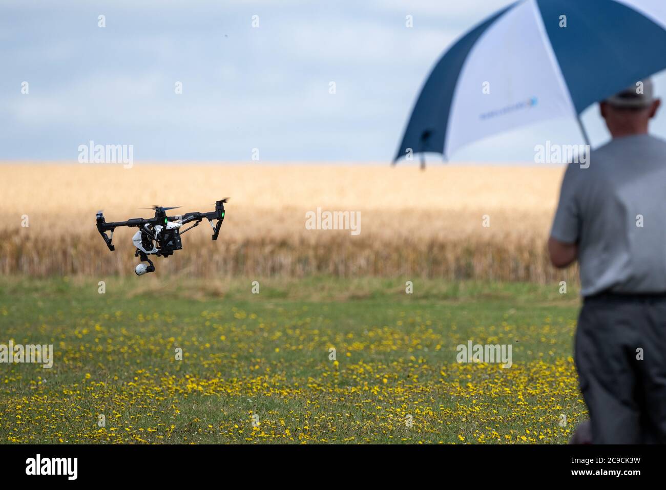 A small UAV drone quadcopter comes in to land, Winchester, UK Stock Photo