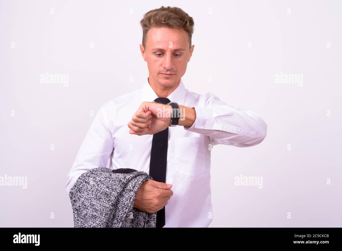 Handsome businessman with blond curly hair against white background Stock Photo