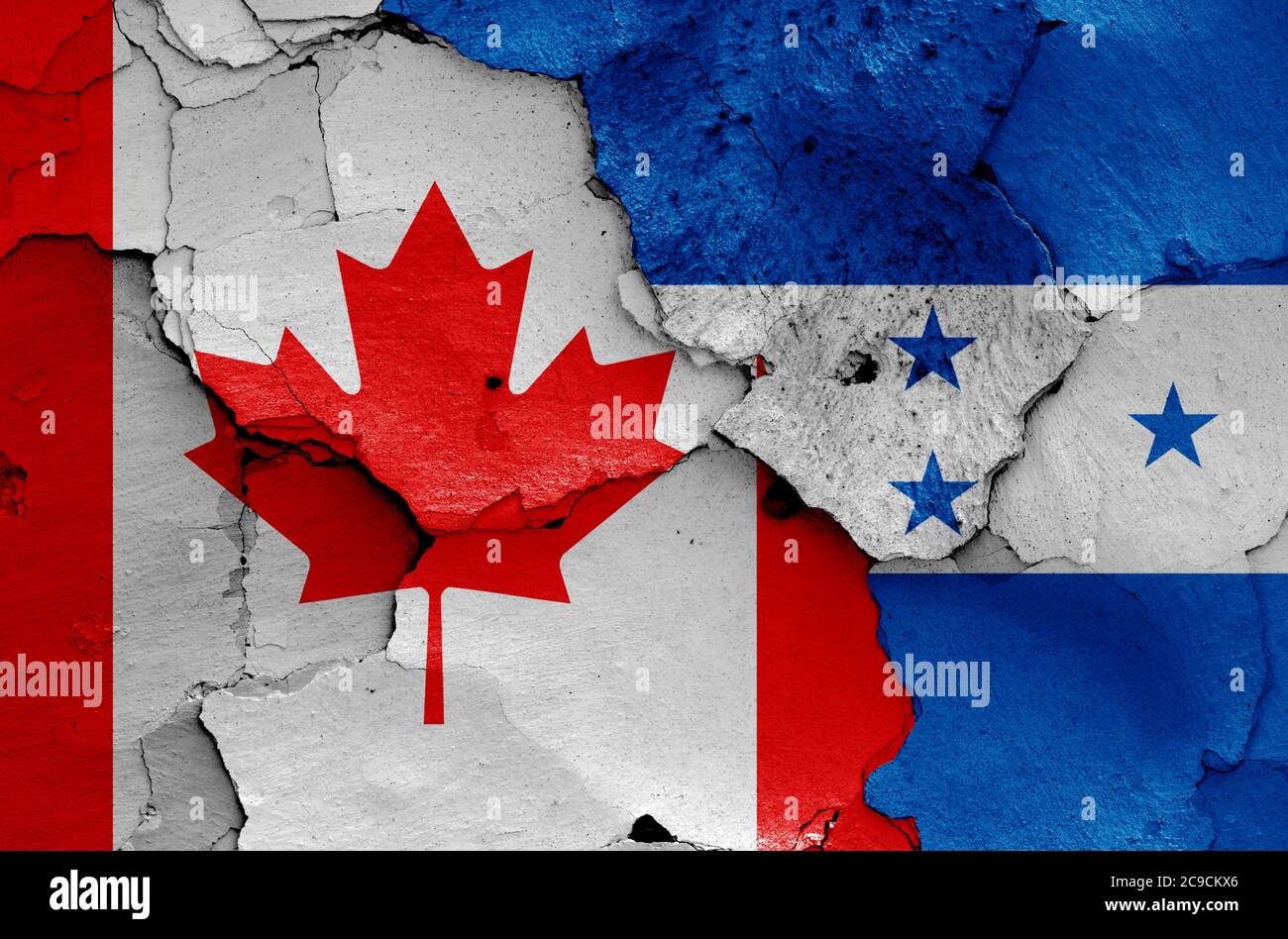flags of Canada and Honduras painted on cracked wall Stock Photo