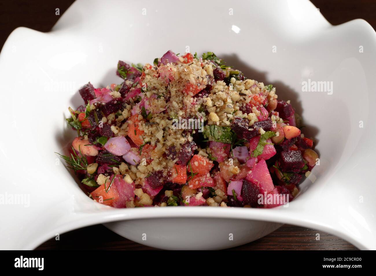 Vegetarian salad served in a restaurant with vegetables vinaigrette, close-up. Photos for restaurant and cafe menus Stock Photo