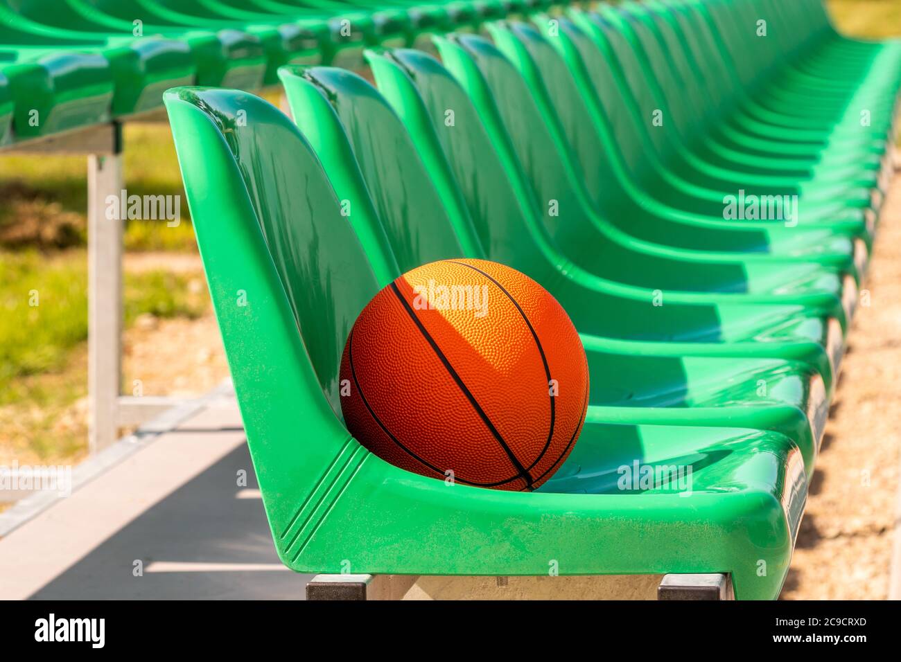 Line of stadium chairs with an orange basketball Stock Photo Alamy