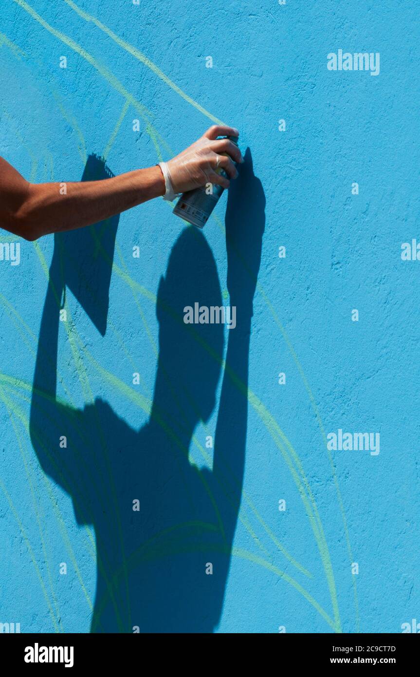 Hand Holding a Spray Can, Graffiti Artist at the Wall Stock Photo - Alamy