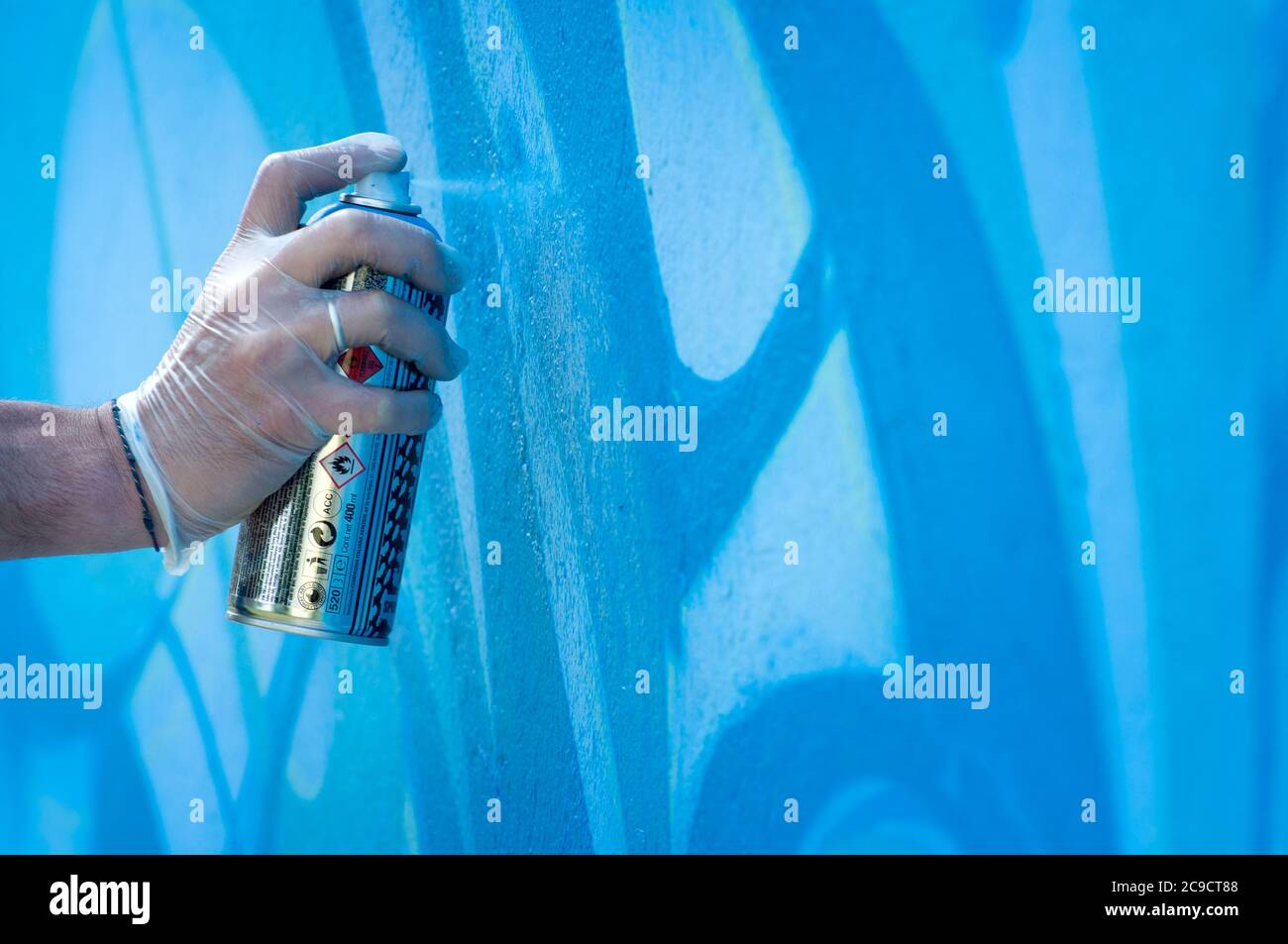 Hand Holding a Spray Can, Graffiti Artist at the Wall Stock Photo - Alamy