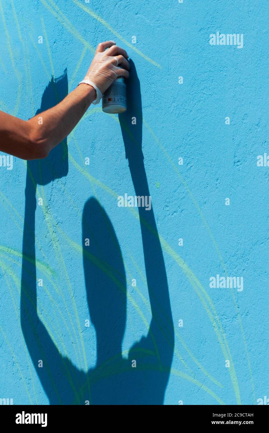 Hand Holding a Spray Can, Graffiti Artist at the Wall Stock Photo - Alamy