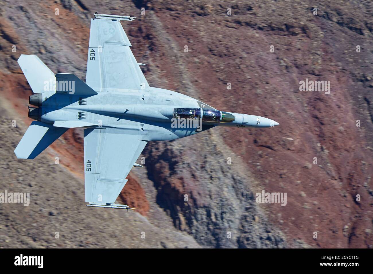Close Up Shot Of A United States Navy F/A-18F, Flying At High Speed And Low Level Through Rainbow Canyon, California, USA. Stock Photo