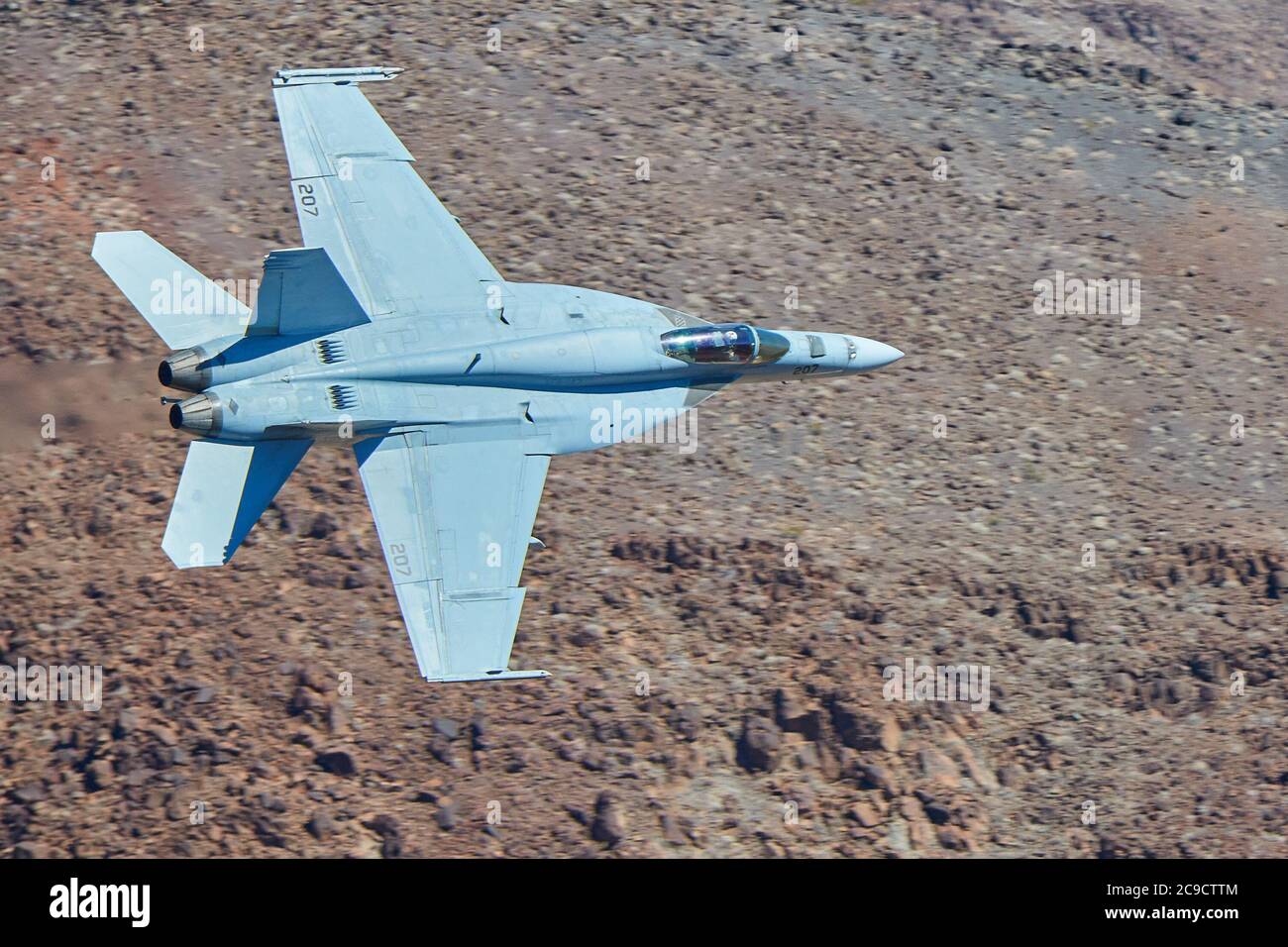 Close Up Shot Of A United States Navy F/A-18E, Flying At High Speed And Low Level Through Rainbow Canyon, California, USA. Stock Photo