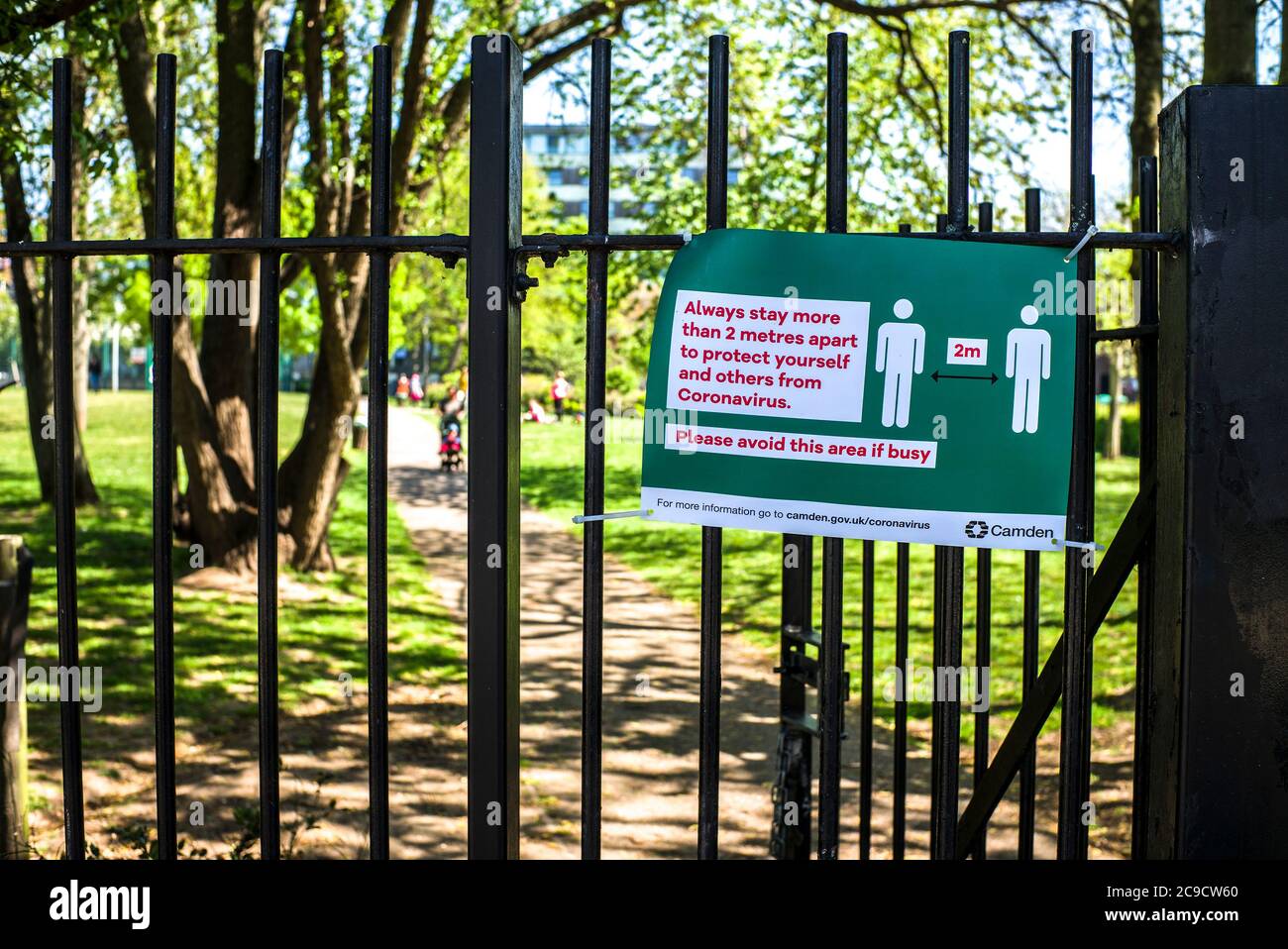 Warning sign Please keep safe distance of 2 m or 6 feet apart corona