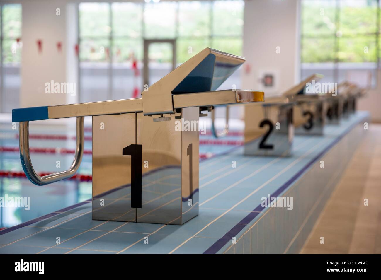 Indoor swimming pool full of water with trampolines on the side Stock Photo Alamy