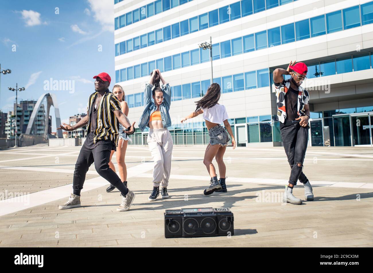 Group of hip hop dancers permorming their dance. Crew making show in an urban place Stock Photo