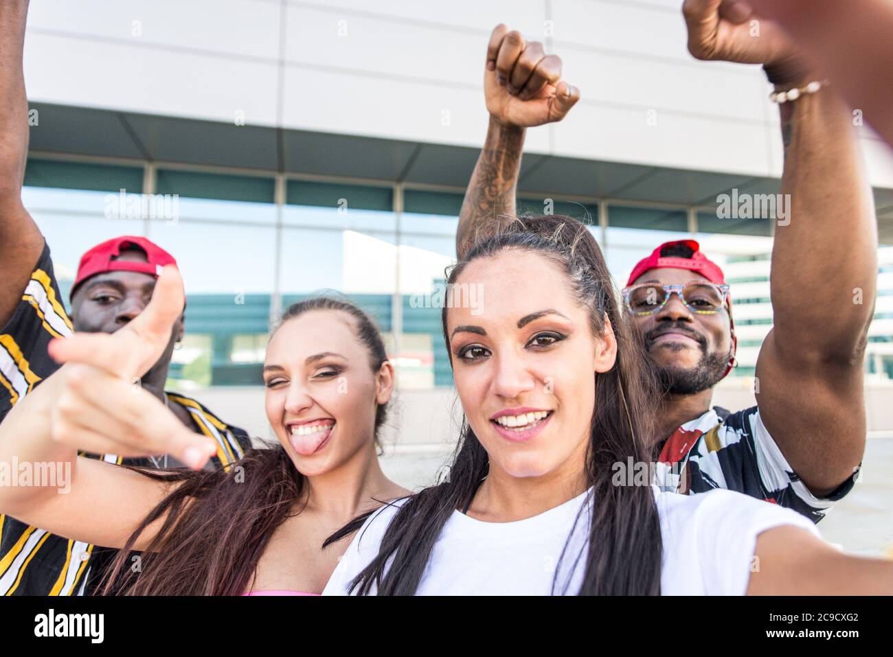 Group of hip hop dancers taking a break and shooting selfies Stock