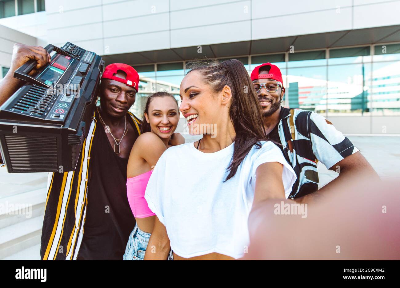 Group of hip hop dancers taking a break and shooting selfies Stock