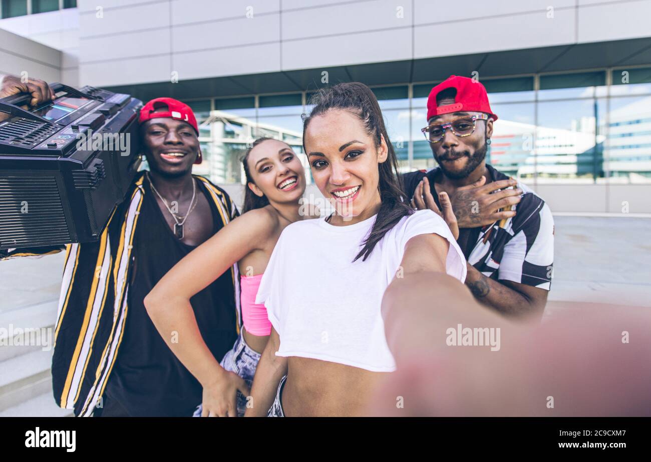 Group of hip hop dancers taking a break and shooting selfies Stock Photo