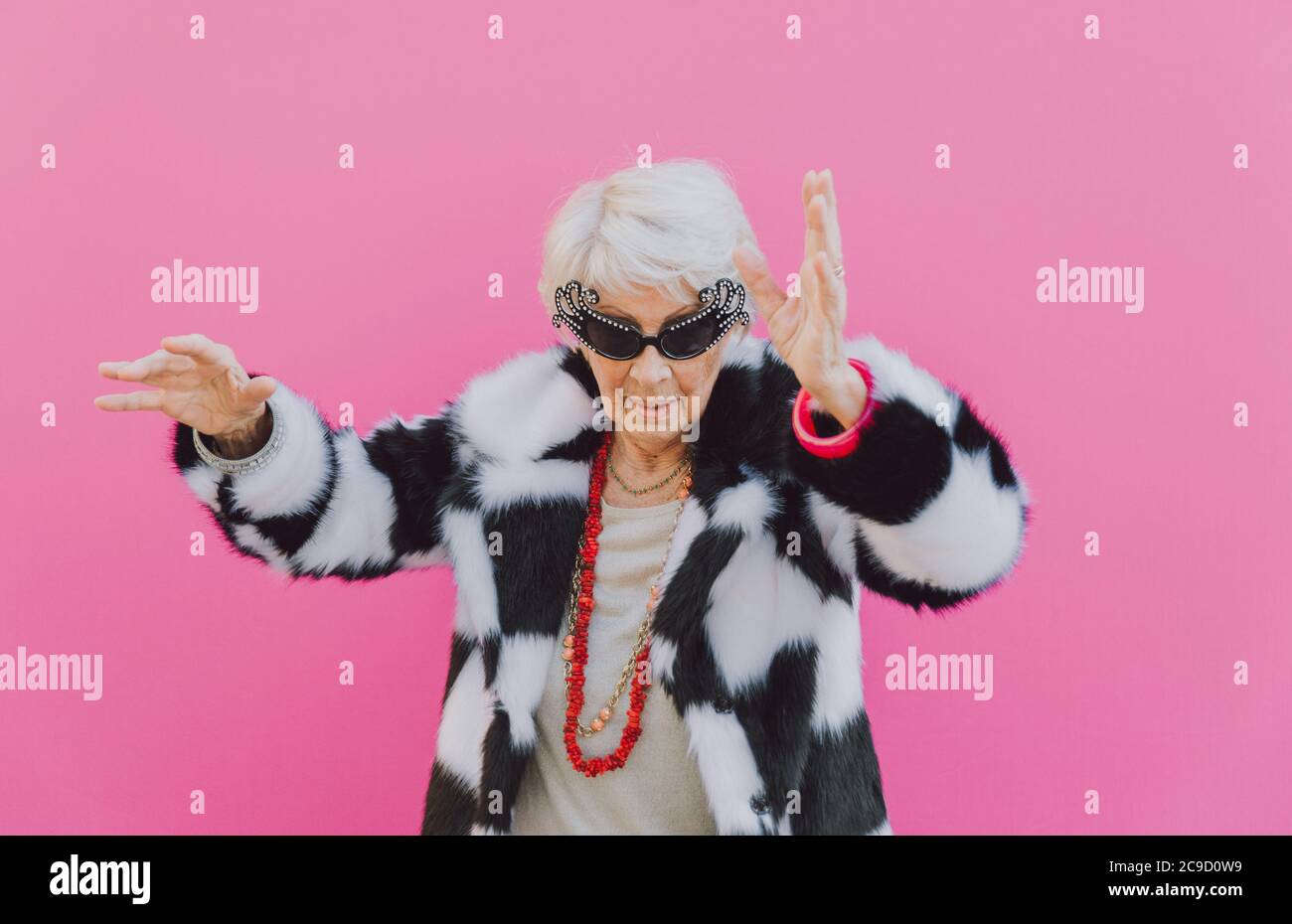 Funny grandmother dancing on colored background Stock Photo - Alamy