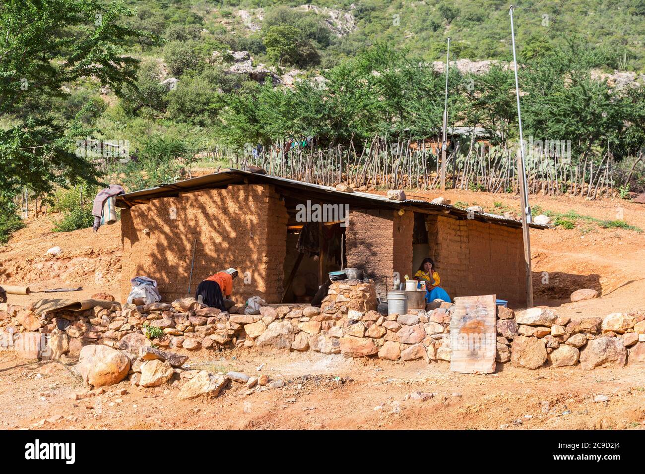 Young girl sits by her simple adobe and log home in the Tarahumara village  of San Alonso in the Copper Canyon area of Mexico Stock Photo - Alamy