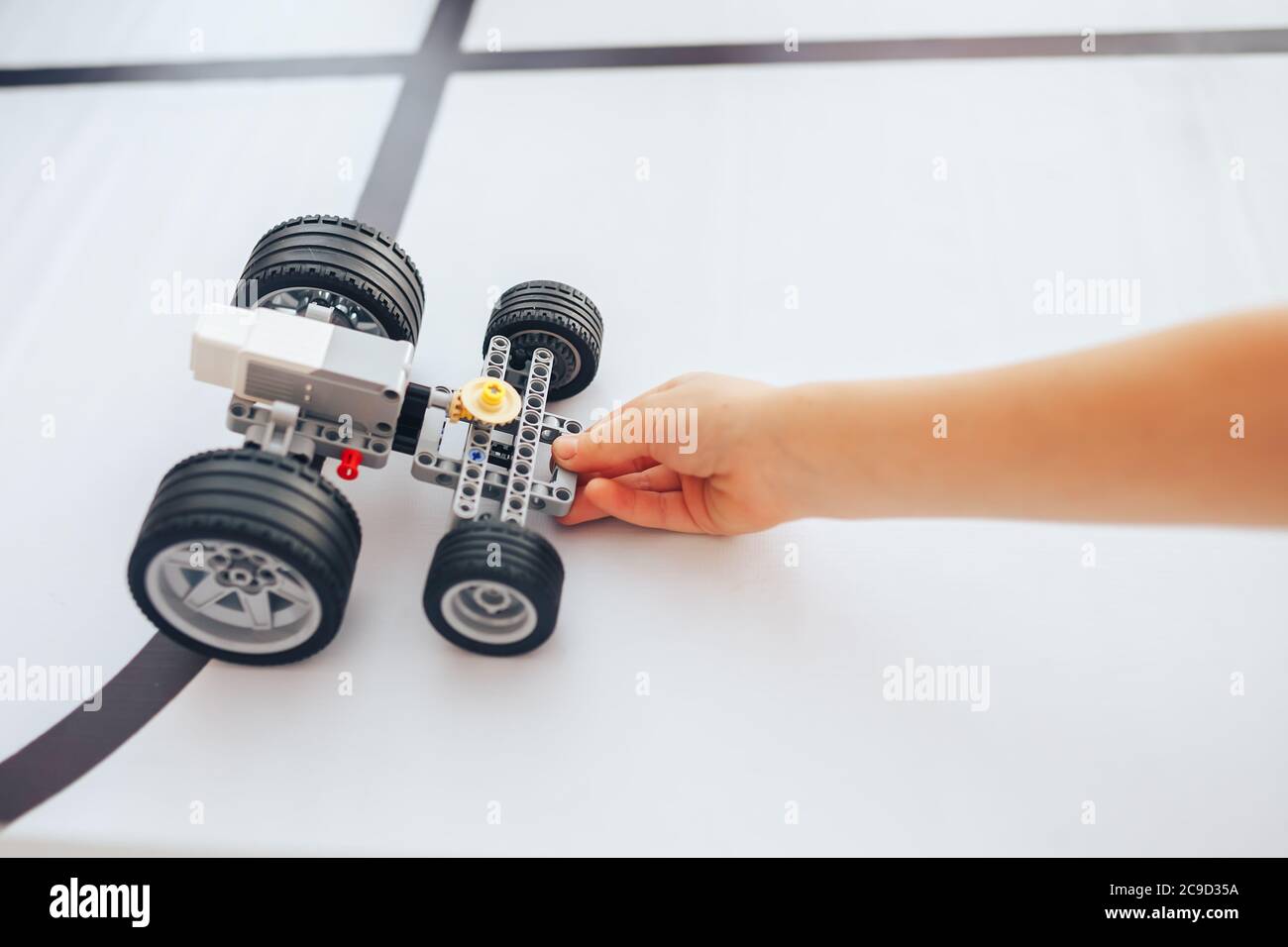 Schoolgirl holding constructor robot in robotics class Stock Photo