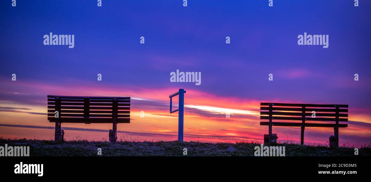 Gager, Germany. 21st May, 2020. The sunset colours the evening sky behind the dyke at the Greifswald Bodden orange-red. Credit: Jens Büttner/dpa-Zentralbild/ZB/dpa/Alamy Live News Stock Photo