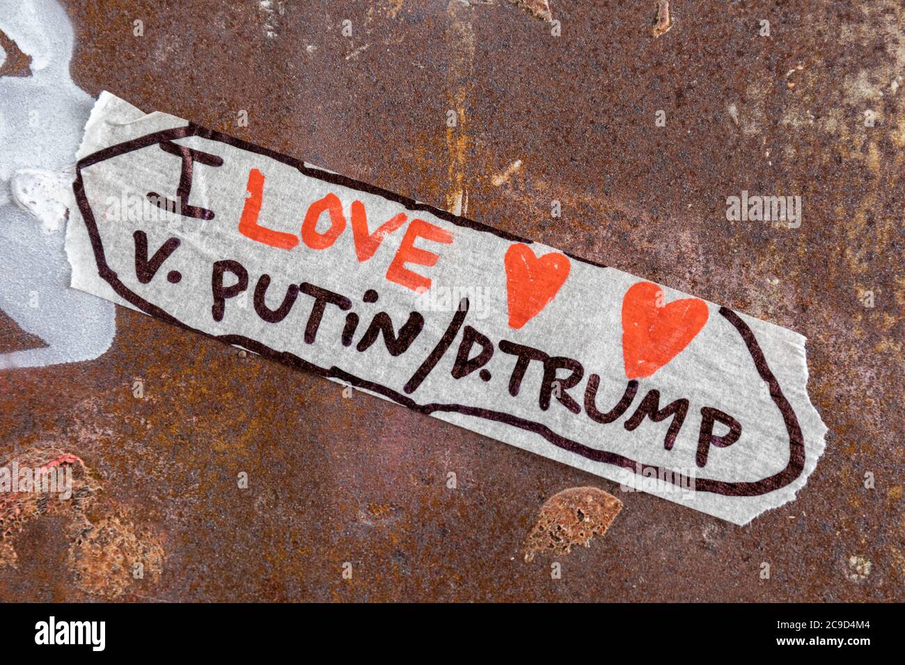 I love V. Putin / D. Trump. Handwritten text on piece of masking tape. Stock Photo