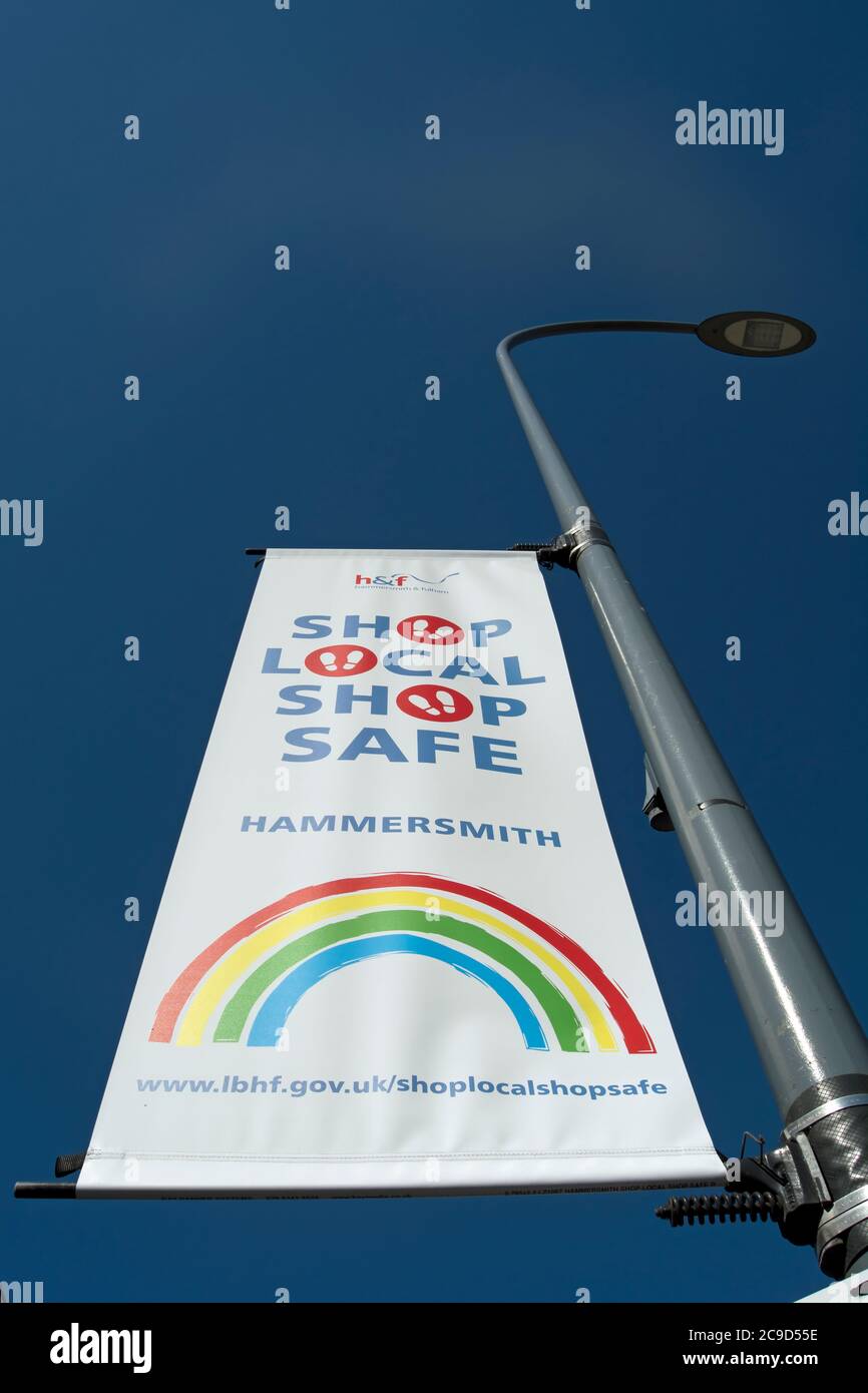 hammersmith and fulham council banner urging shop local shop safe, during the 2020 covid 19 pandemic, hammersmith, london, england Stock Photo