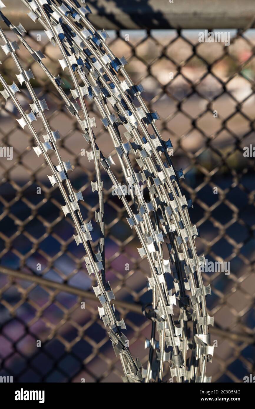 Razor Wire Lines Fence of Pedestrian Bridge Crossing US-Mexico Border from Ciudad Juarez to El Paso. Stock Photo