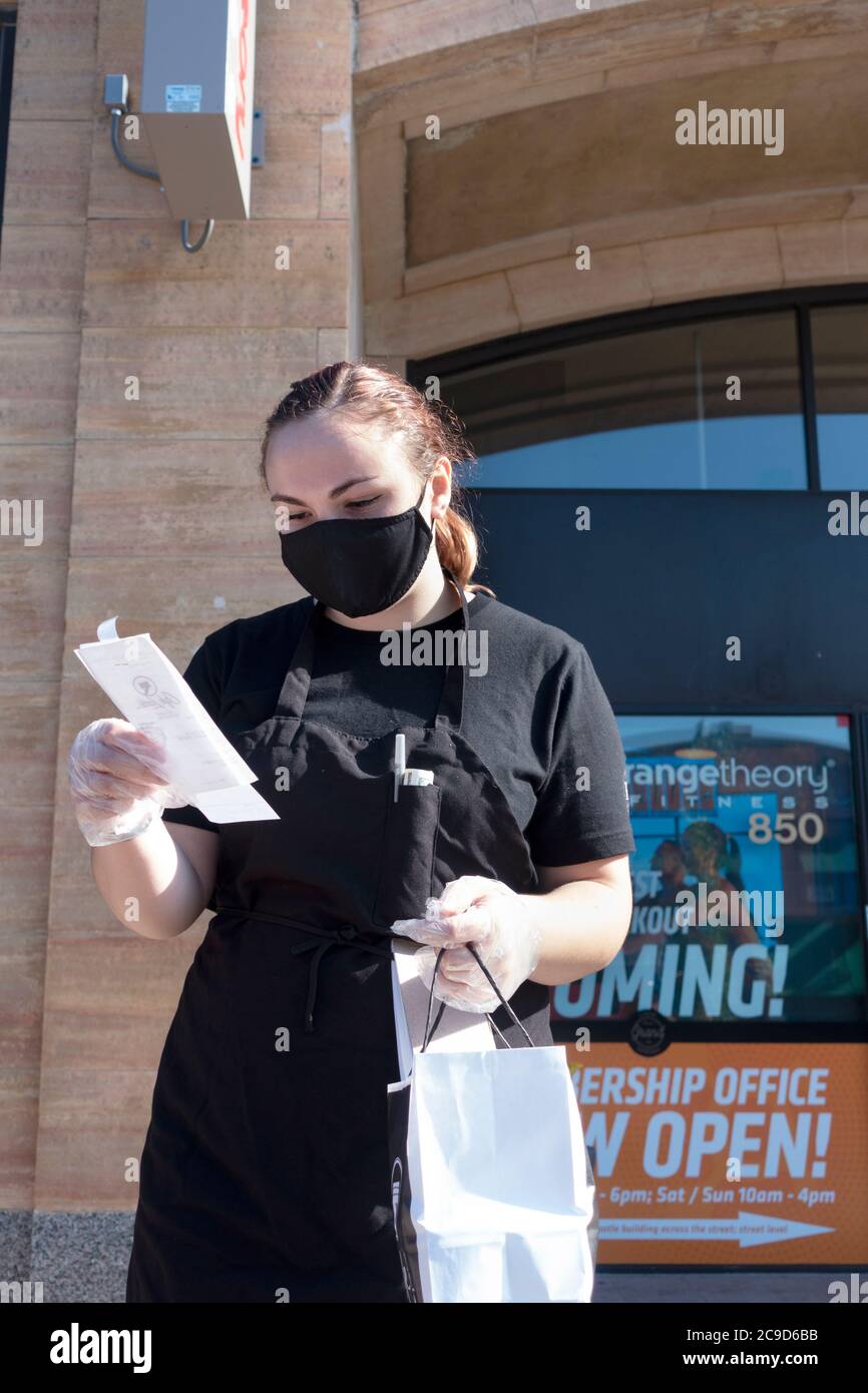 Masked and gloved waitperson checking the food order at Cafe Latte for curbside pick up. St Paul Minnesota MN USA Stock Photo