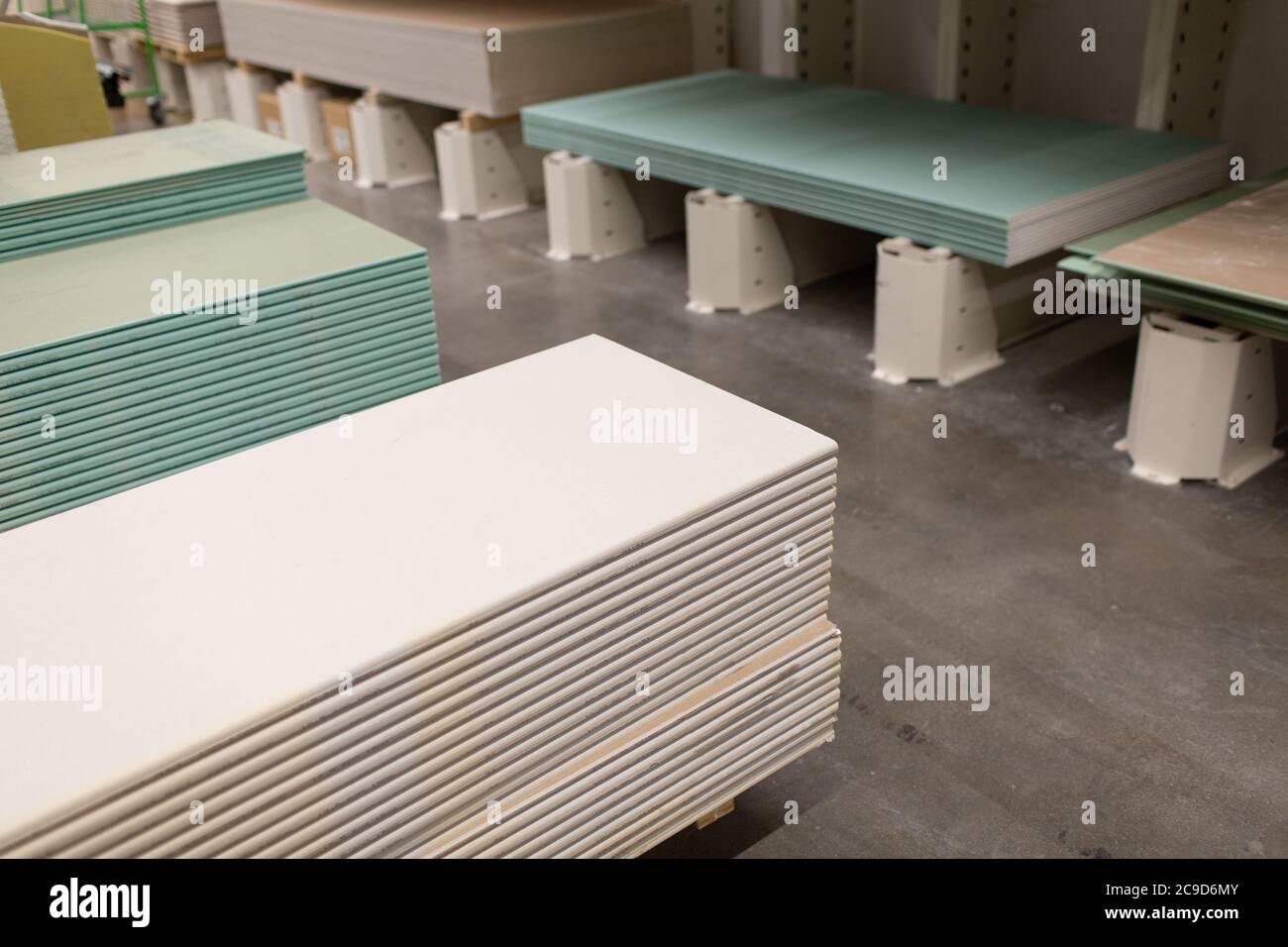 Pallet with Drywall sheets plasterboard in the building warehouse store. Stock Photo