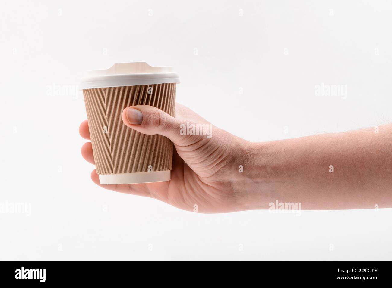 Hand holding a corrugated paper cup on white background Stock Photo - Alamy