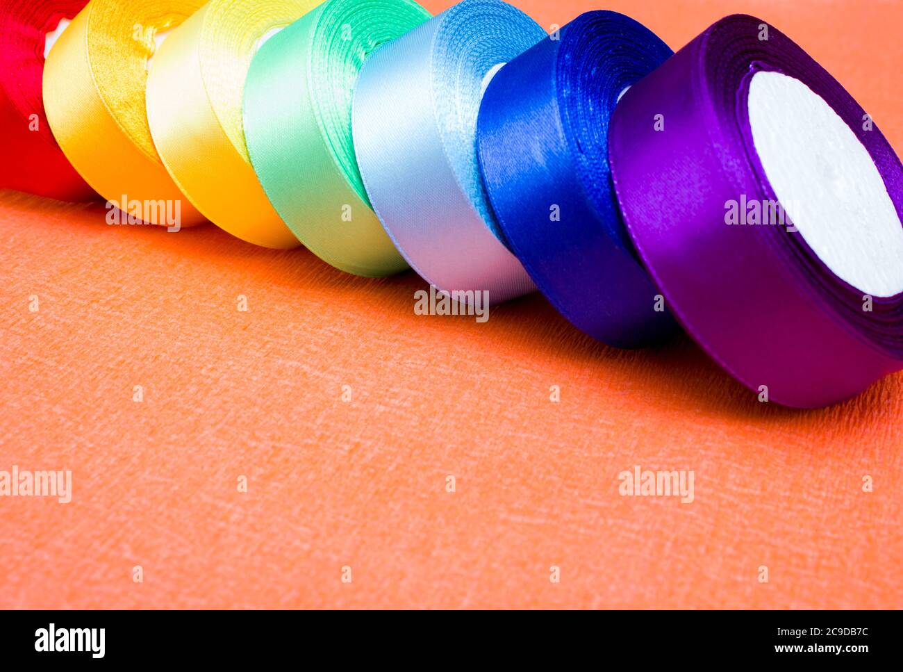 Rolls of satin ribbons multicolored for hobbies, crafts Stock Photo