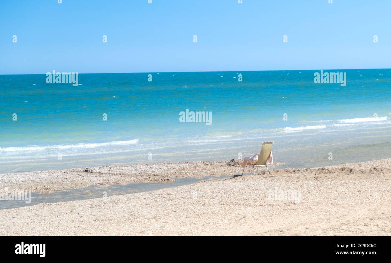 empty chair on the beach. Beach with blue sky and sea in summer as vacation concept. tourism crisis. coronavirus  Stock Photo