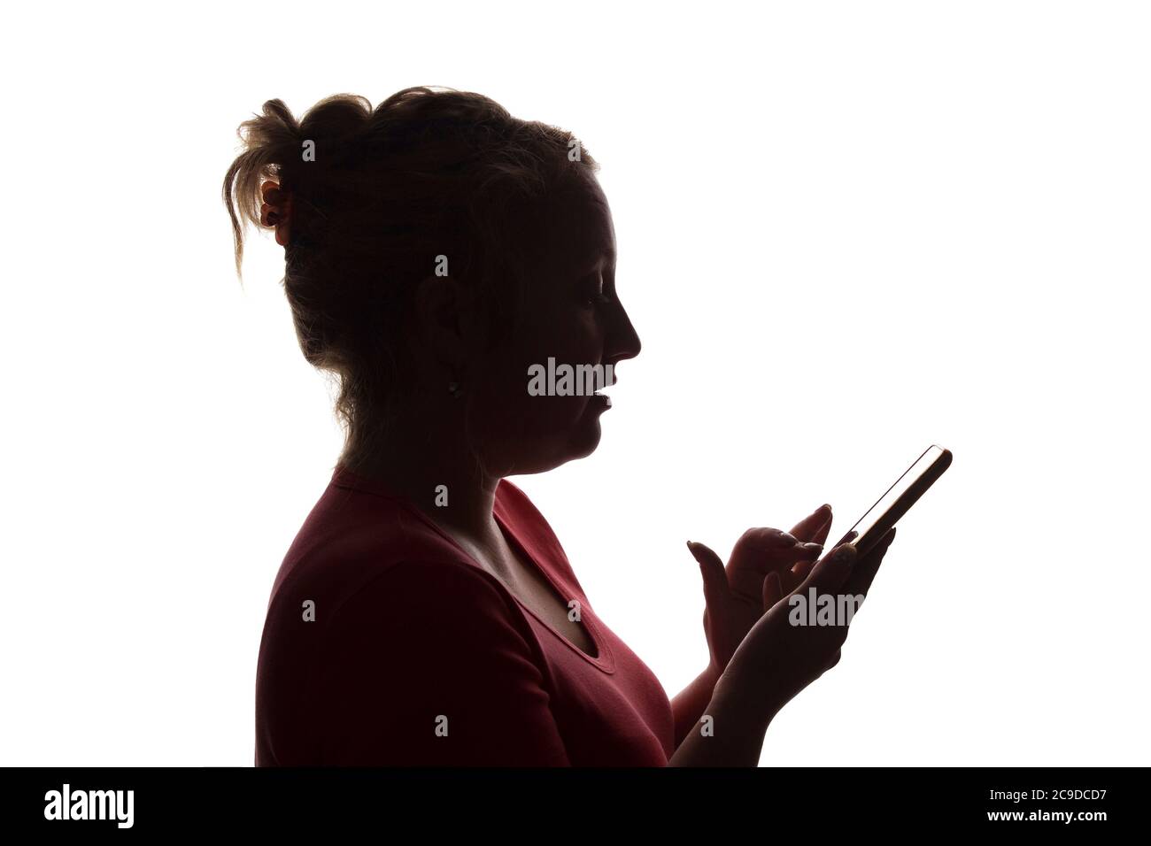 Silhouette of a girl with a mobile smart phone - isolated, technology Stock Photo