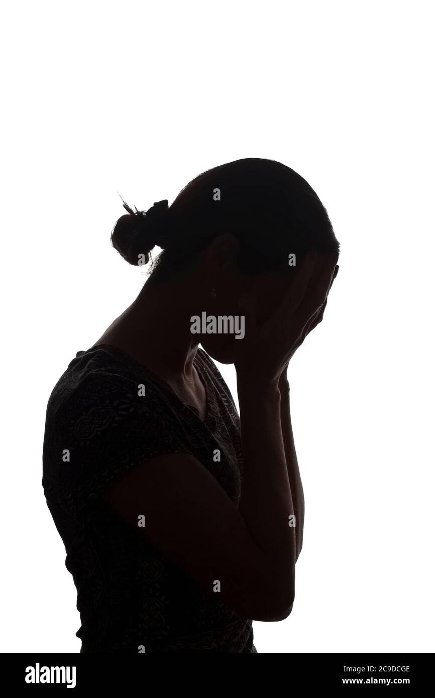 Silhouette of a young girl with problems, side view with hands on her head - isolated, noname Stock Photo