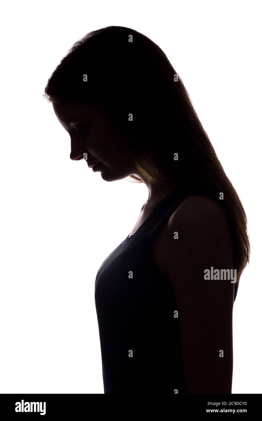 Young woman look down with flowing hair vertical, isolated silhouette