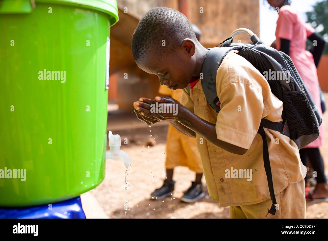 A child washes his hands at a hand washing station at his school in Conakry, Guinea, West Africa. Stock Photo