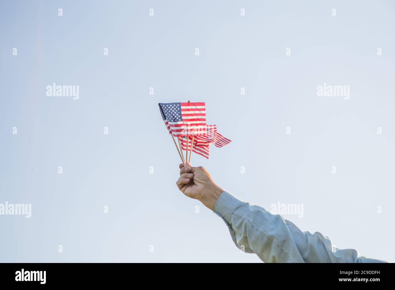 Patriotic senior man celebrates usa independence day on 4th of July with a national flag in his hands. Constitution and Citizenship Day. National Gran Stock Photo