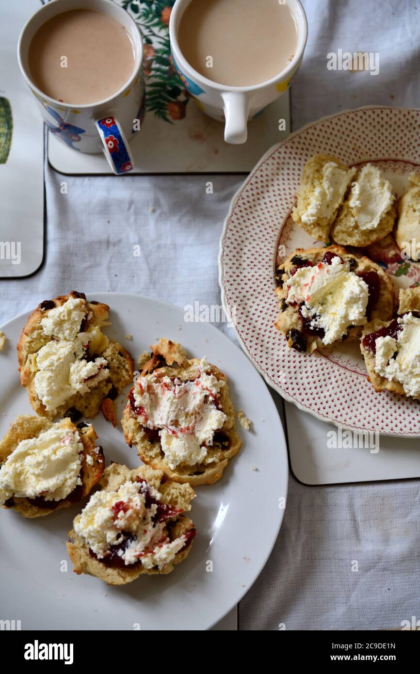 Scones with Strawberry Jam , Clotted Cream and a Mug of Tea Stock Photo
