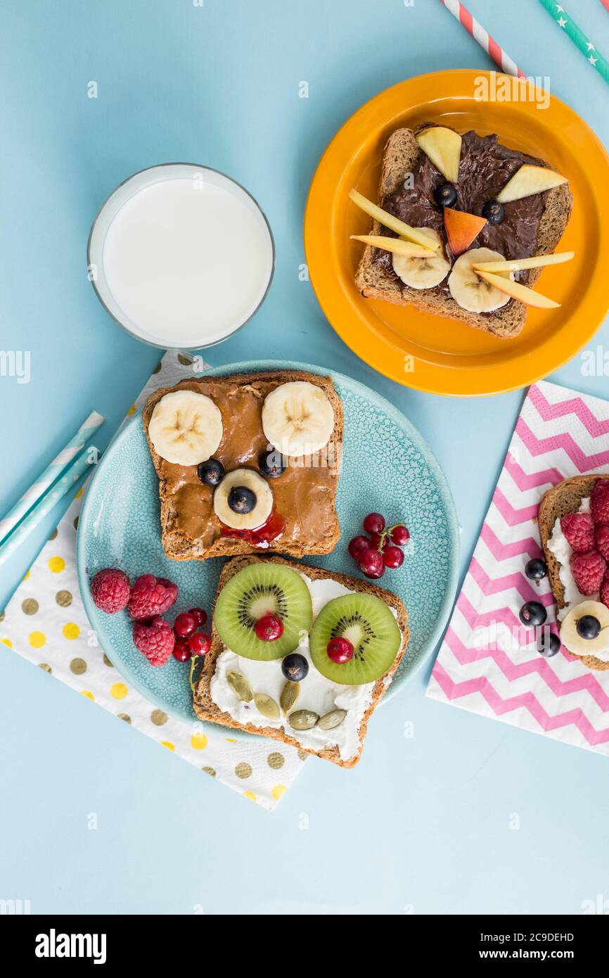 Funny breakfast toast for kids shaped as cute cat, dog, bear, fish