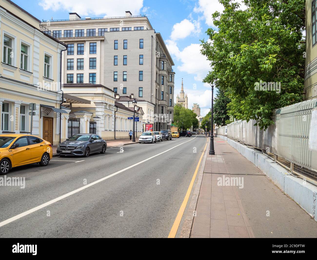 MOSCOW, RUSSIA - JULY 19, 2020: view of Malaya Nikitskaya street and skyscraper on horizon in Moscow city in summer. The street was formed in the 17th Stock Photo