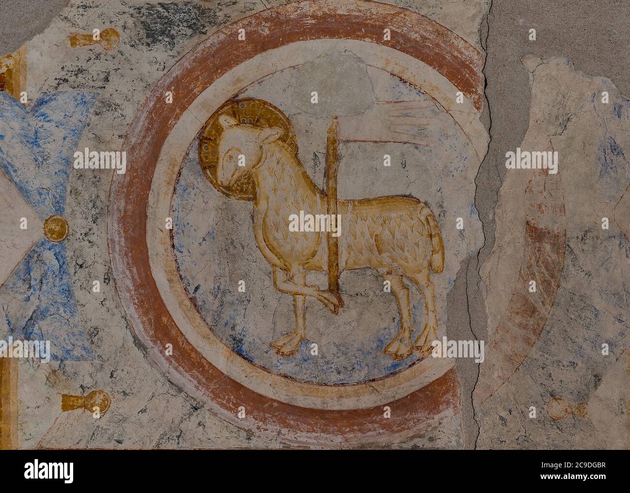 Agnus Dei, a Romanesque fresco of a lamb with a flag in a round medallion in the vault of Hagested church, Denmark, July 16, 2020 Stock Photo