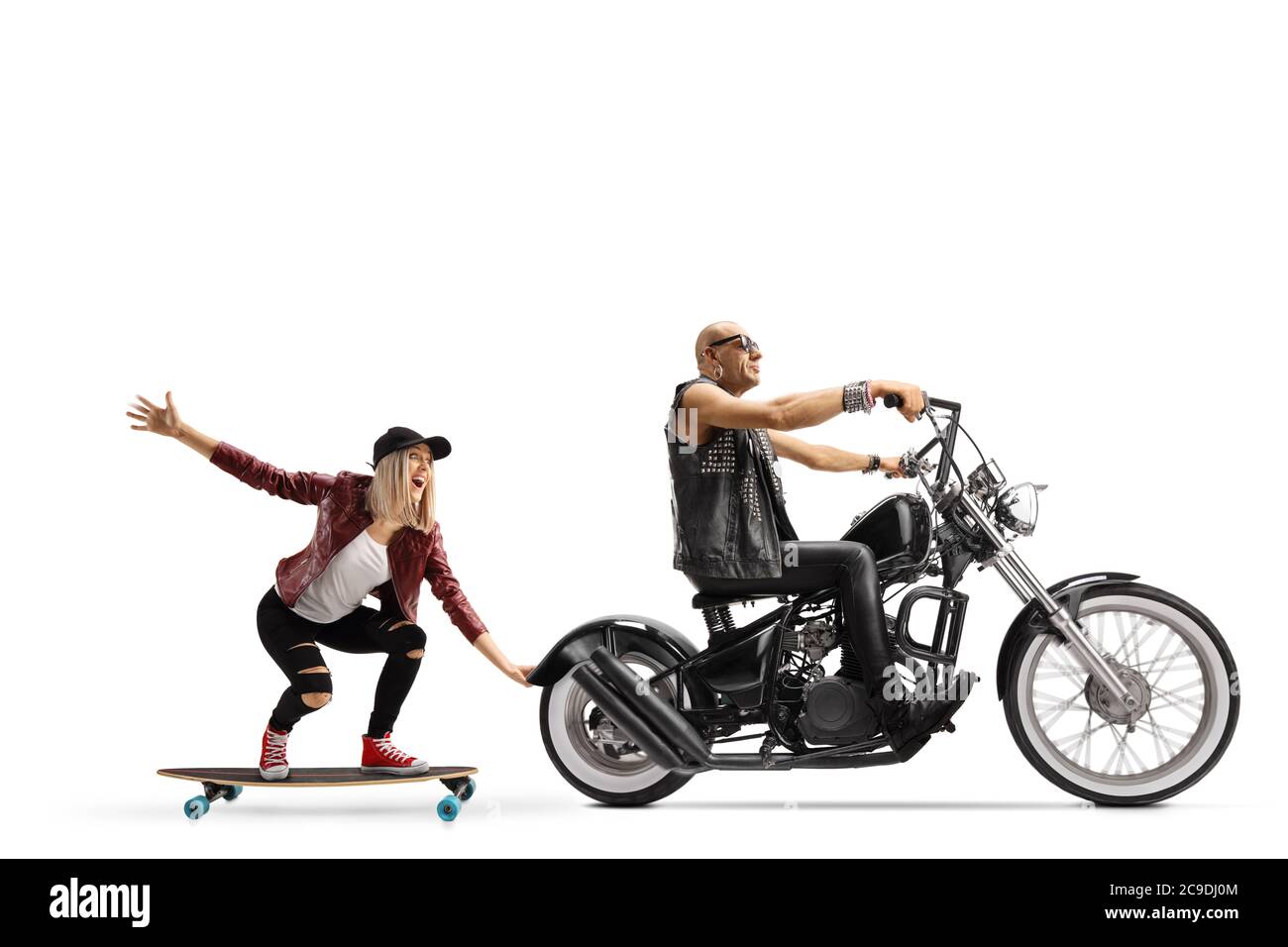 Man riding a chopper and a young female riding a skateboard and holding  onto the motorbike isolated on white background Stock Photo - Alamy