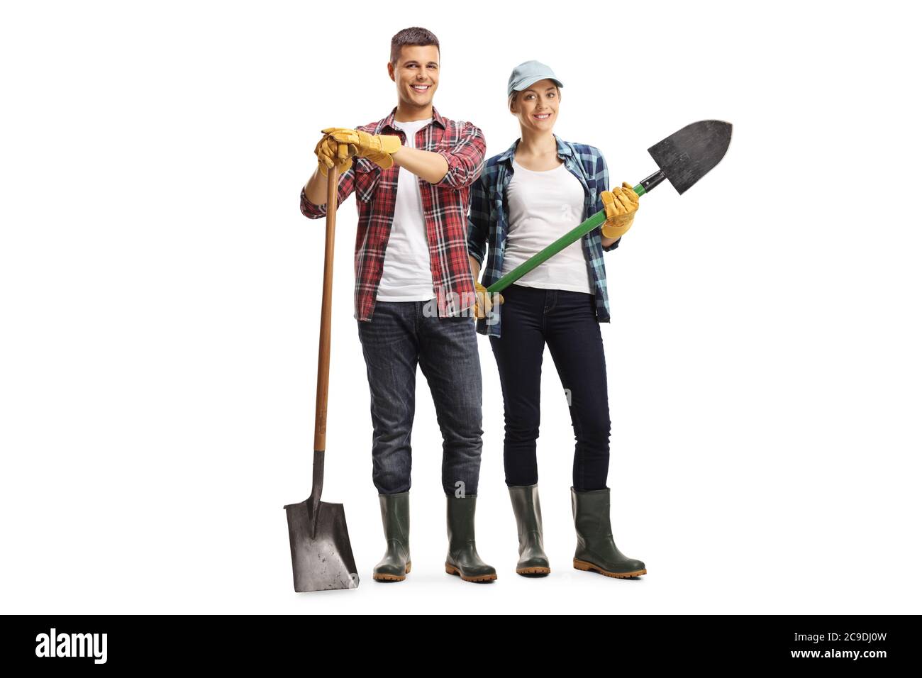 Full length portrait of young couple gardeners standing with shovels isolated on white background Stock Photo