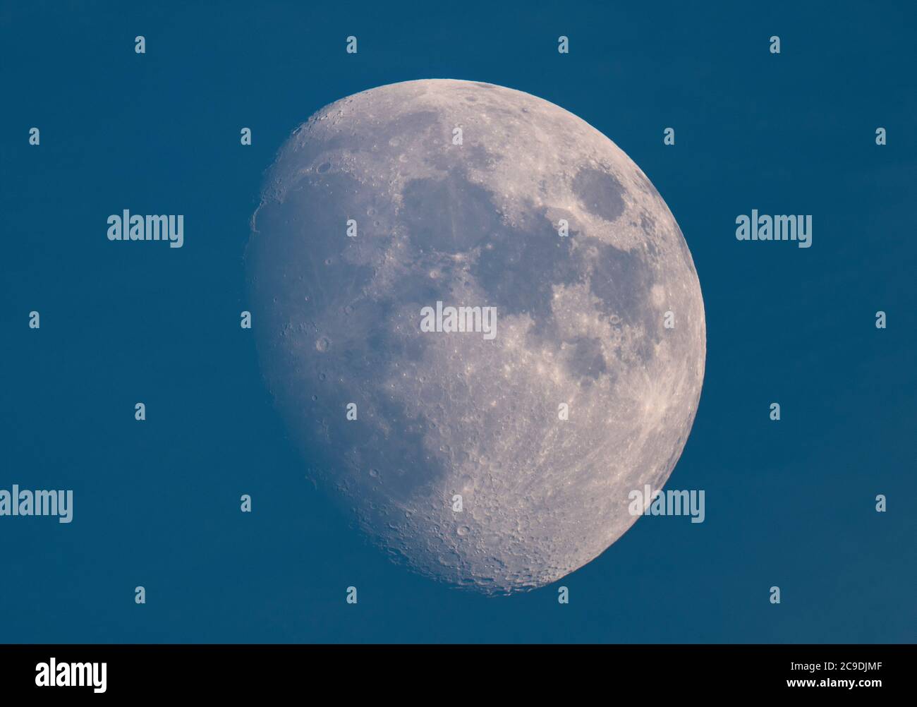 London, UK. 30 July 2020. An 84% illuminated Waxing Gibbous Moon above London in blue sky and a clear atmosphere, photographed through a telescope, showing crater detail on the south lunar pole. Credit: Malcolm Park/Alamy Live News Stock Photo