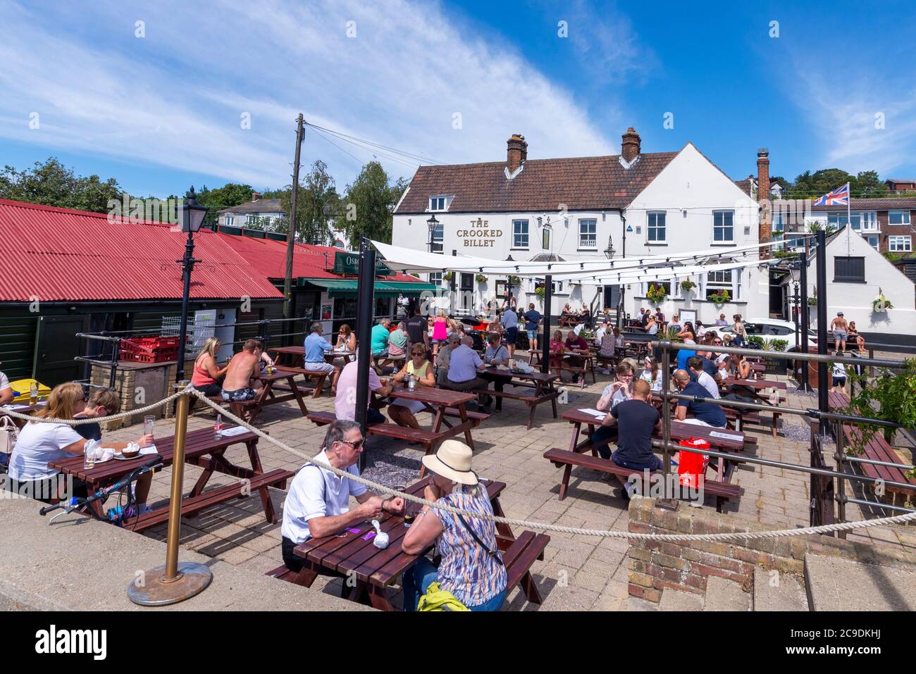The Crooked Billet pub, with associated outdoor tables for customers outside on Billet Wharf. Busy with customers during COVID-19 Coronavirus lockdown Stock Photo