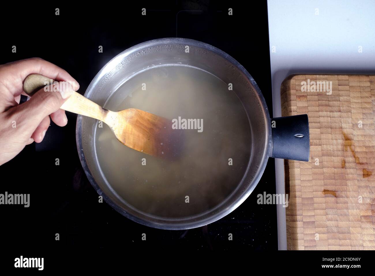 Wooden spoon in pot hi-res stock photography and images - Alamy