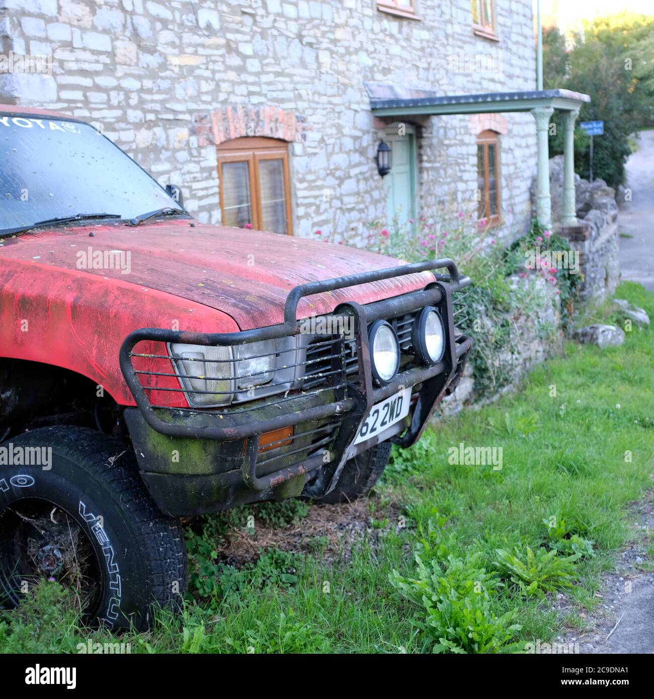 July 2020 - Old red Toyota pickup truck rotting away unloved. Stock Photo