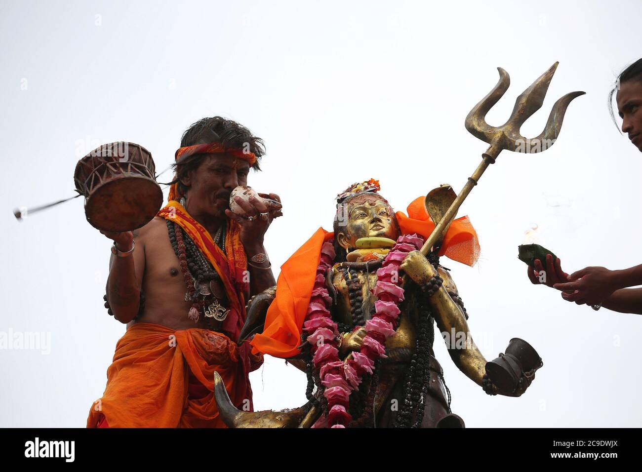 Kathmandu, Nepal. 30th July, 2020. A Hindu priest offers prayers to idol of Lord Shiva at Shiva temple during the holy month of Shrawan. Shrawan month is considered as the holiest month of the year to offer prayers to Lord Shiva for happiness and prosperity. (Photo by Archana Shrestha/Pacific Press) Credit: Pacific Press Media Production Corp./Alamy Live News Stock Photo