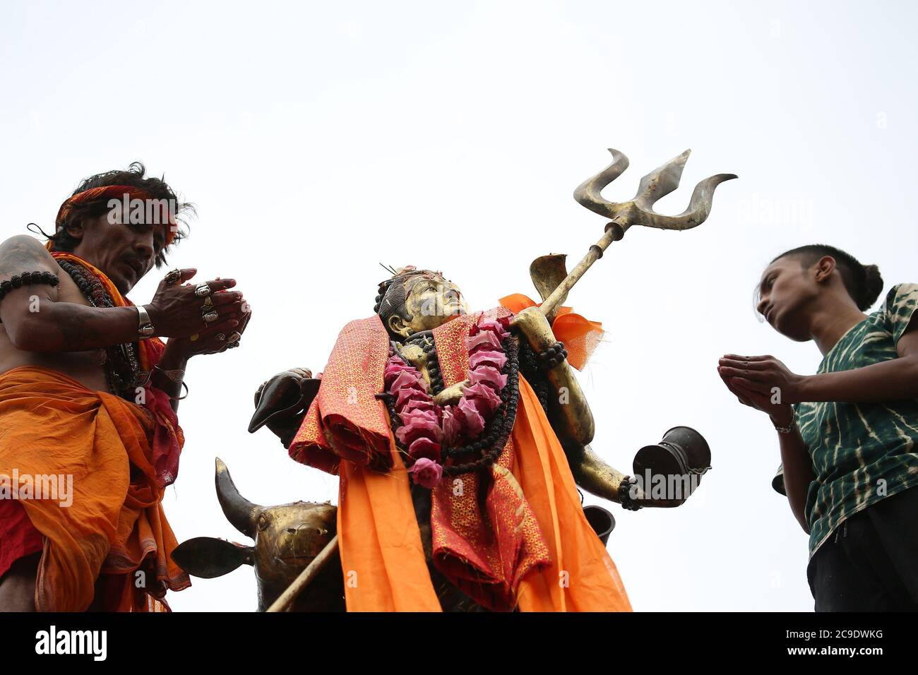 Kathmandu, Nepal. 30th July, 2020. Devotees offer prayers to idol of Lord Shiva at Shiva temple during the holy month of Shrawan. Shrawan month is considered as the holiest month of the year to offer prayers to Lord Shiva for happiness and prosperity. (Photo by Archana Shrestha/Pacific Press) Credit: Pacific Press Media Production Corp./Alamy Live News Stock Photo