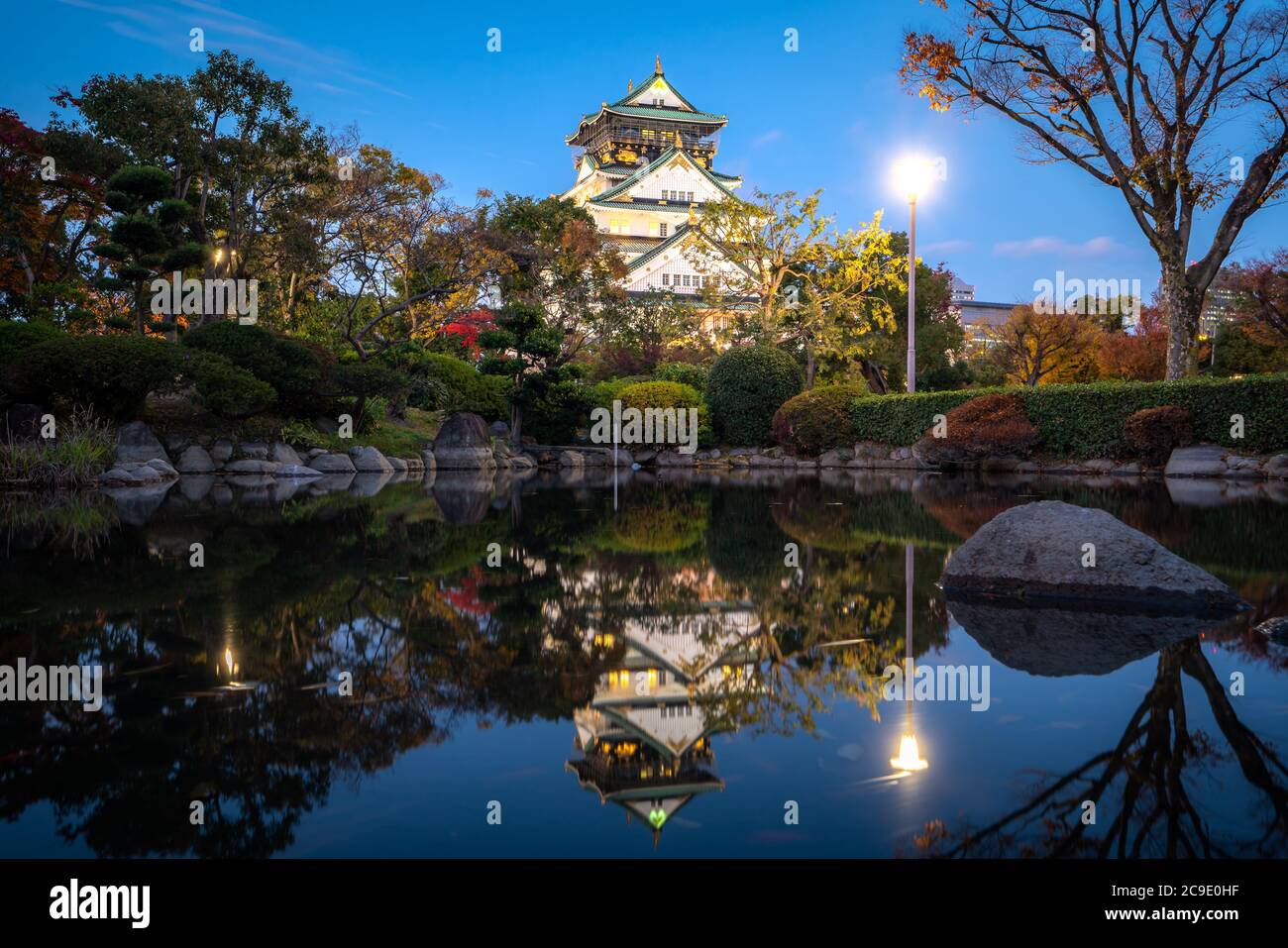 Osaka Castle with Japanese garden and reflection in pond at autumn season at night in Osaka, Japan. Japan tourism, history building, or tradition cult Stock Photo