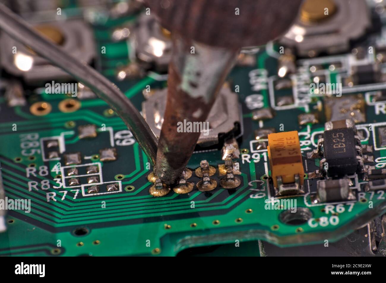 soldering iron on circuit board assembly. Electronic components Stock Photo