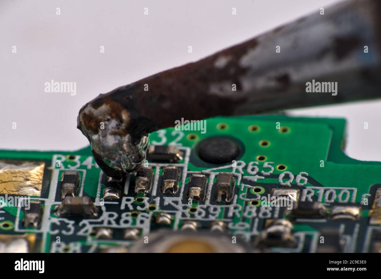 soldering iron on circuit board assembly. Electronic components Stock Photo