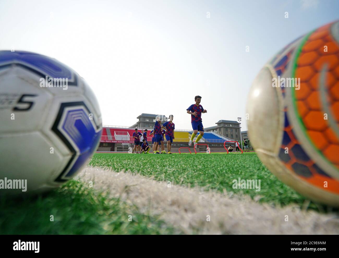 Renqiu, China's Hebei Province. 30th July, 2020. Student players participate in a school football team training session on the playground at Renqiu School Affiliated to Beijing Normal University in Renqiu City, north China's Hebei Province, July 30, 2020. Credit: Mu Yu/Xinhua/Alamy Live News Stock Photo