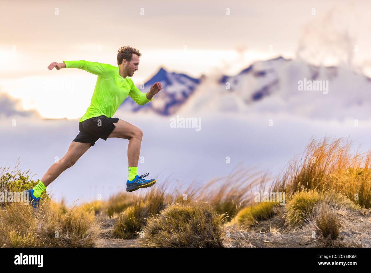 Trail runner man running on New Zealand mountains nature. Sport athlete